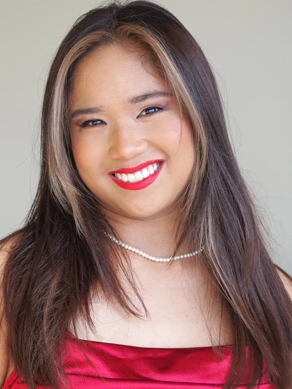 Prom glam with bouncy curls, with vivid red lip and warm glowing skin