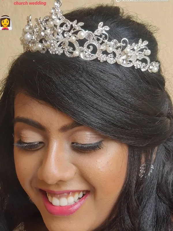 Close-up of church bride with pearl and crystal tiara and dewy skin