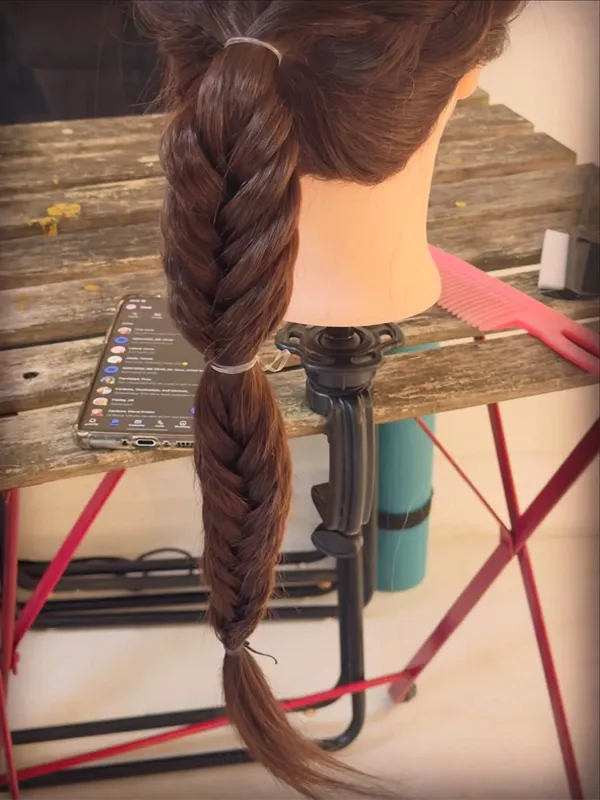 Back view of a long rope fishtail braid on a mannequin head