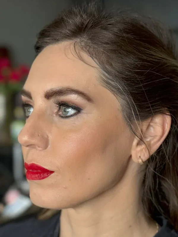 Warm rose eyeshadow and dusty pink lip glam with hoop earrings